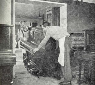 An old piano is taken into the workroom for reconditioning | The Gazette of the John Lewis Partnership 4th May 1957