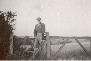 John Spedan Lewis by the gates at Leckford