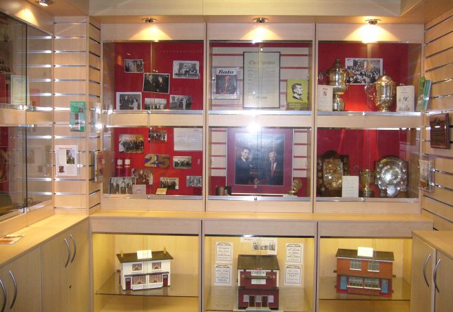 Display cabinets with memorabilia including models of the houses. | From the private collection of J.Spence