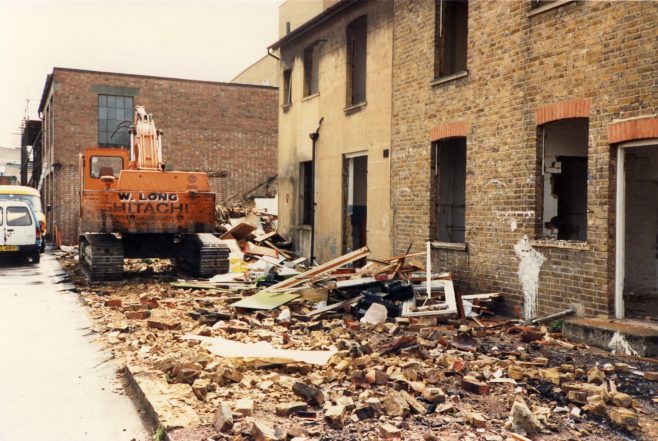 The Cottages between the shop and the Kinghams warehouse awaiting demolition. | JLP Archive Collection.