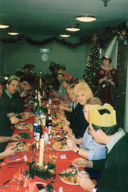 Partners Dave Gardner, Anne Woolcott, Ann Brookes, Anne Stevens, Joe Handman, Josie Pennell and Pam Krisson  tuck in to lunch with Greta Dignan, then Registrar, making sure everyone is served. | From a private collection