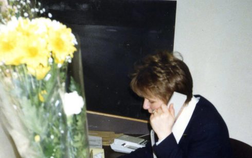 Pam Bodger with her birthday flowers in the Robert Sayle Cash Office