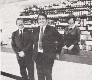 Nearest to the camera is Mr George Green - Manager, with Mr Ron Farley - Deputy Manager besides him.  Miss Georgina Craythorne - Office Manager behind the counter.