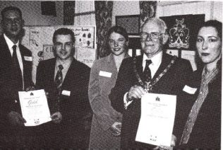 L to R: Cirencester's Catering Manager Chris Skey, Environmental Health Officer Gareth Harvey, DM Customer Services Nicola Burr, Councillor Bruce Evans and Branch Cook Sarah Hannis, display the two Gold Awards